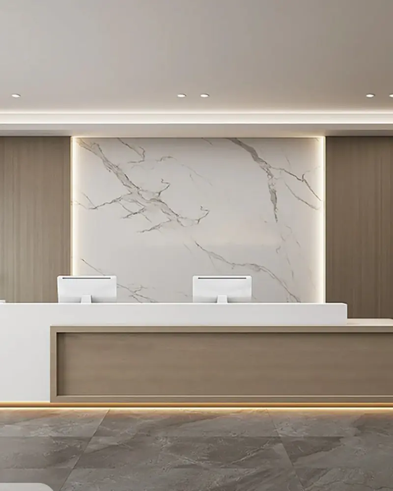 Corporate reception with a stone-clad backdrop, warm oak panelling and a sculpted white desk